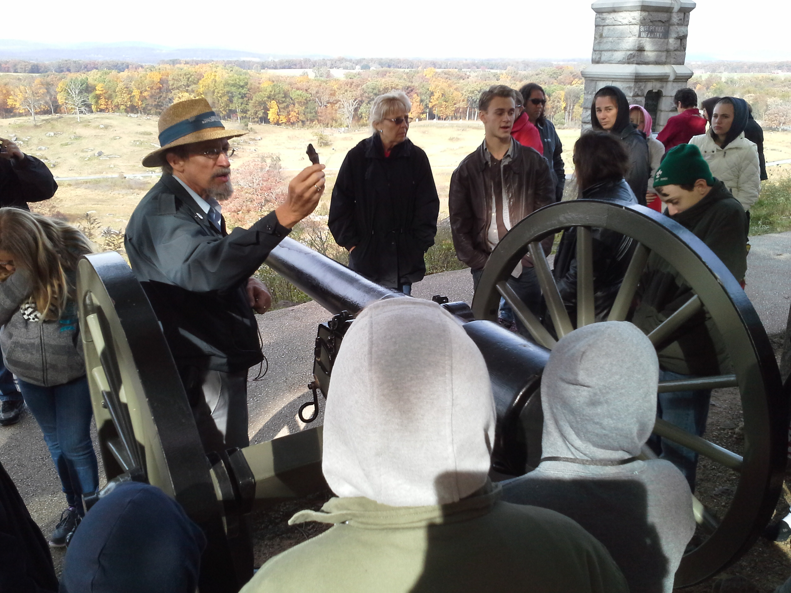 Middle school students standing around a civil war canon listing to an educational tour guide - 14 little round top