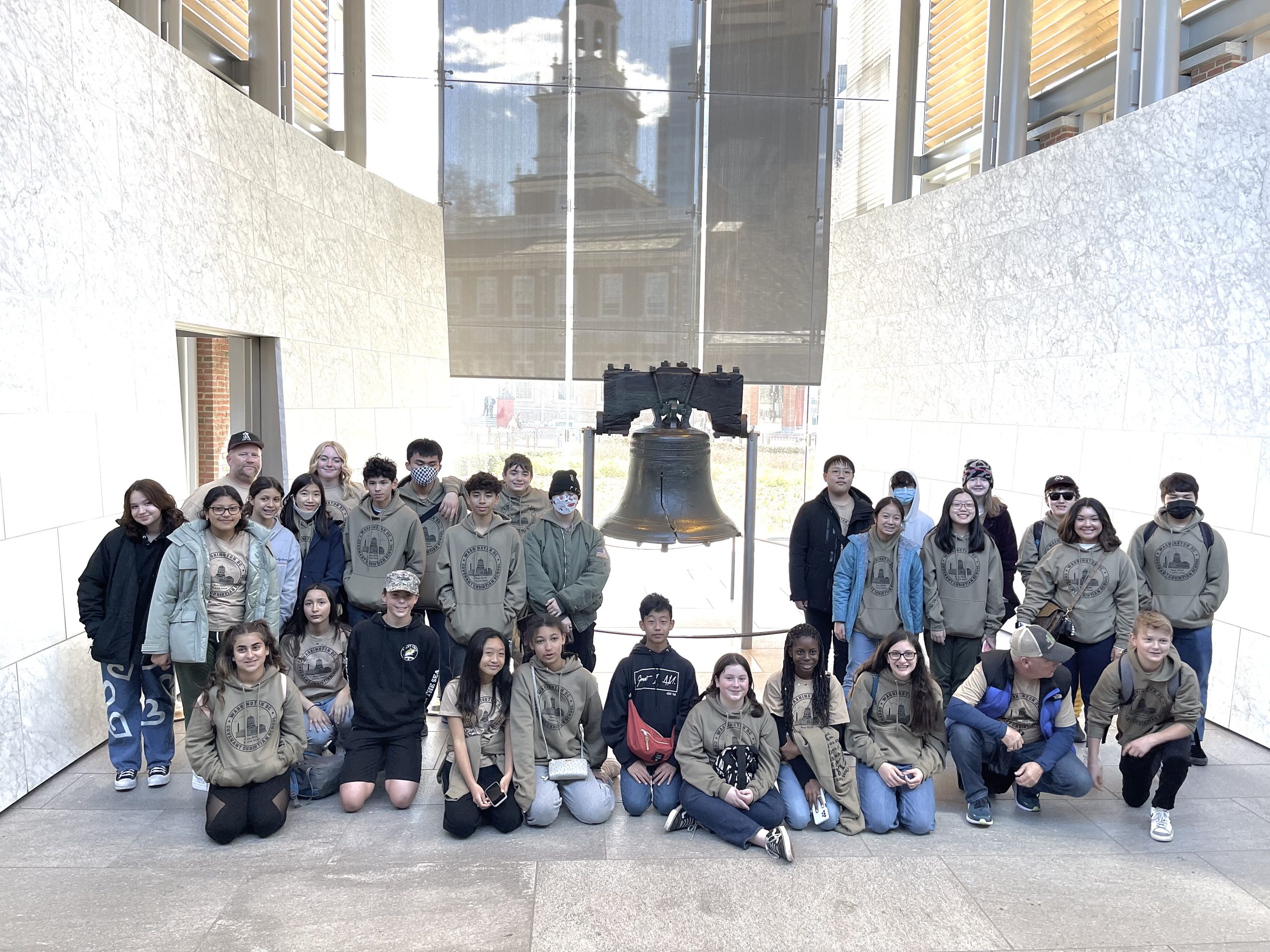 group of middle school students posing by the liberty bell in Philadelphia PA