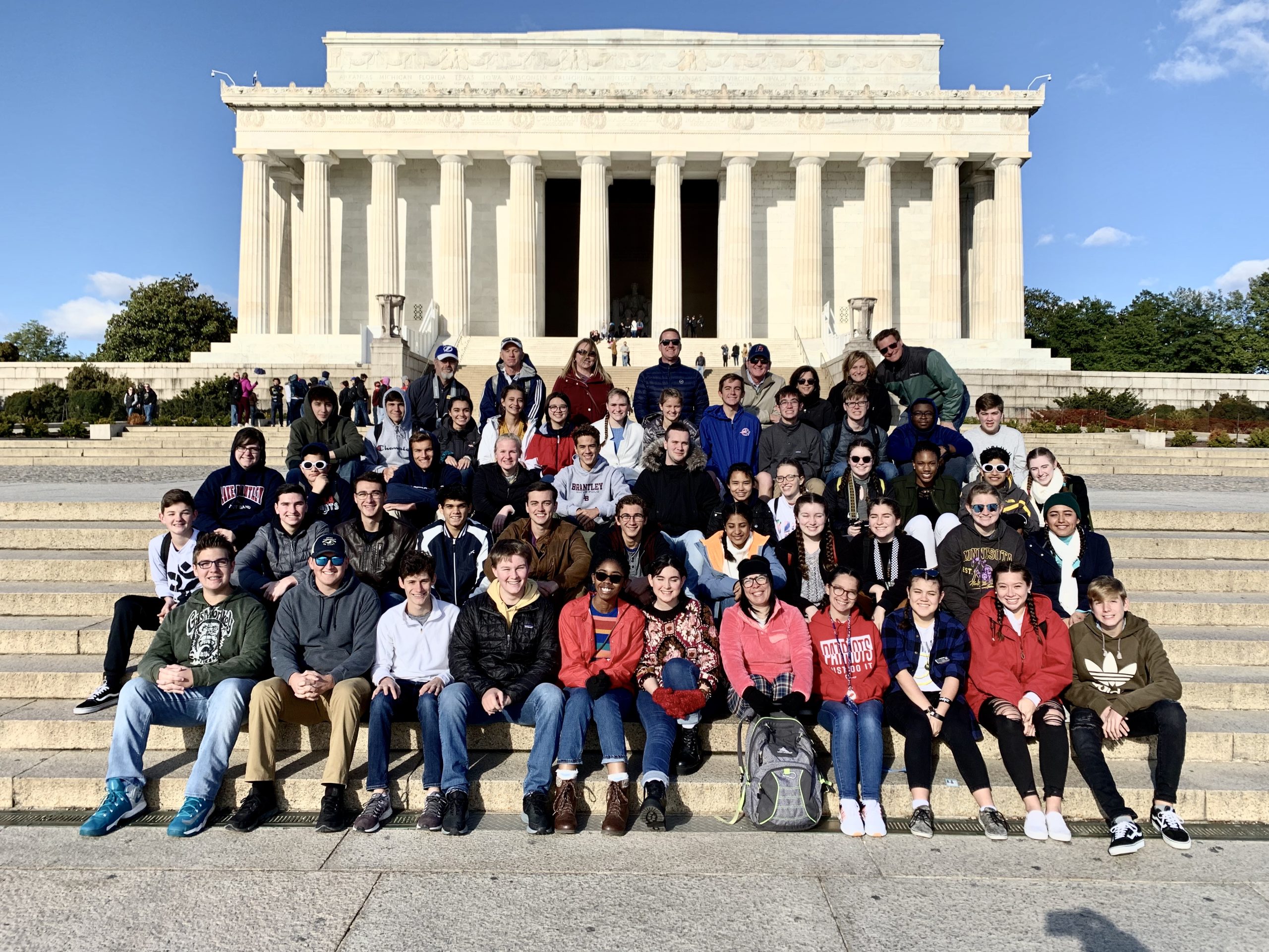 Group of high school students posing on the steps of the Lincoln Memorial in Washington DC