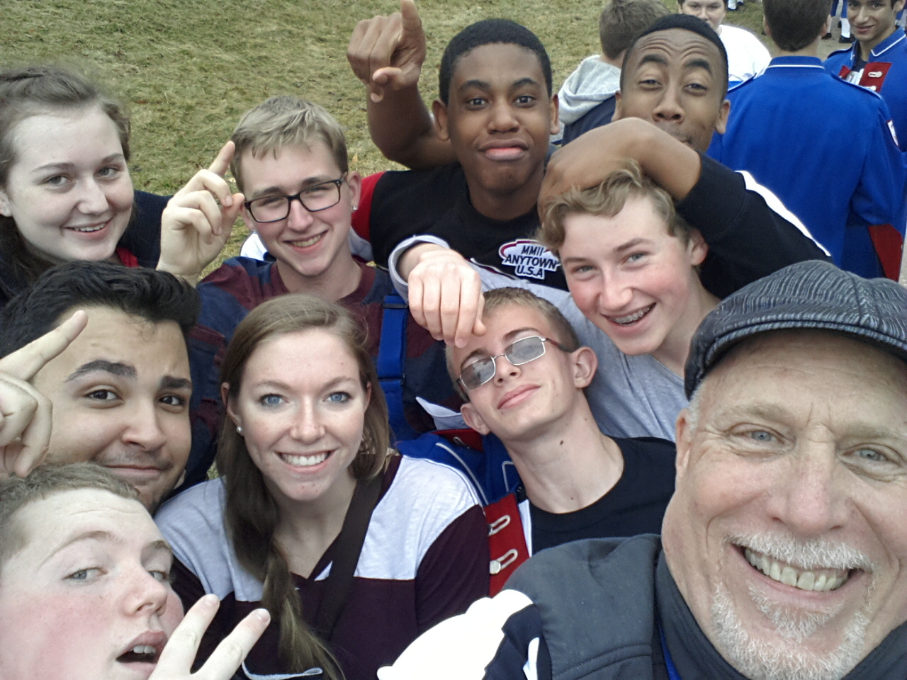 Group of middle school students and educational tour guide posing for a selfie
