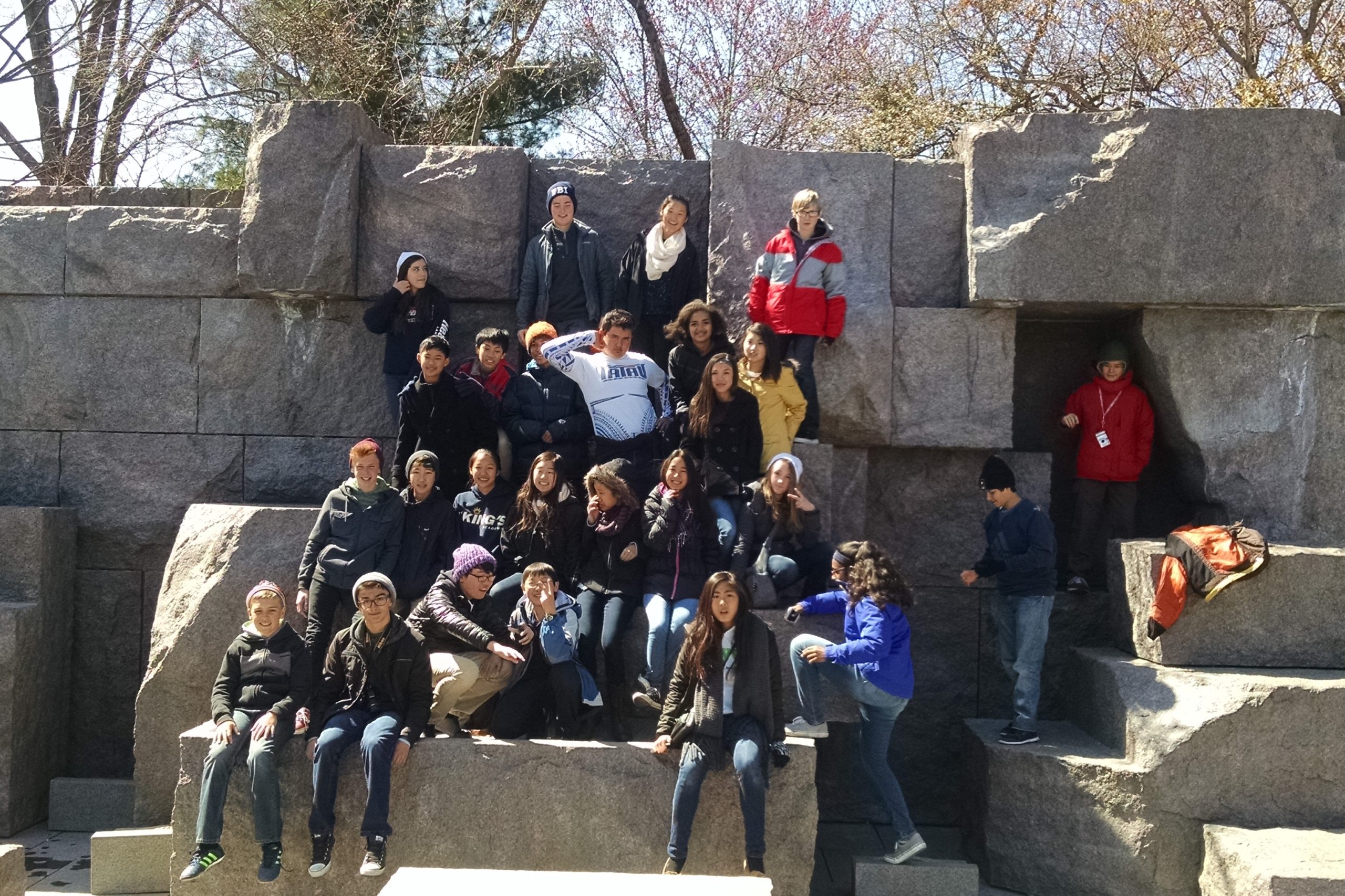 Group of high school students posing in front of the FDR memorial