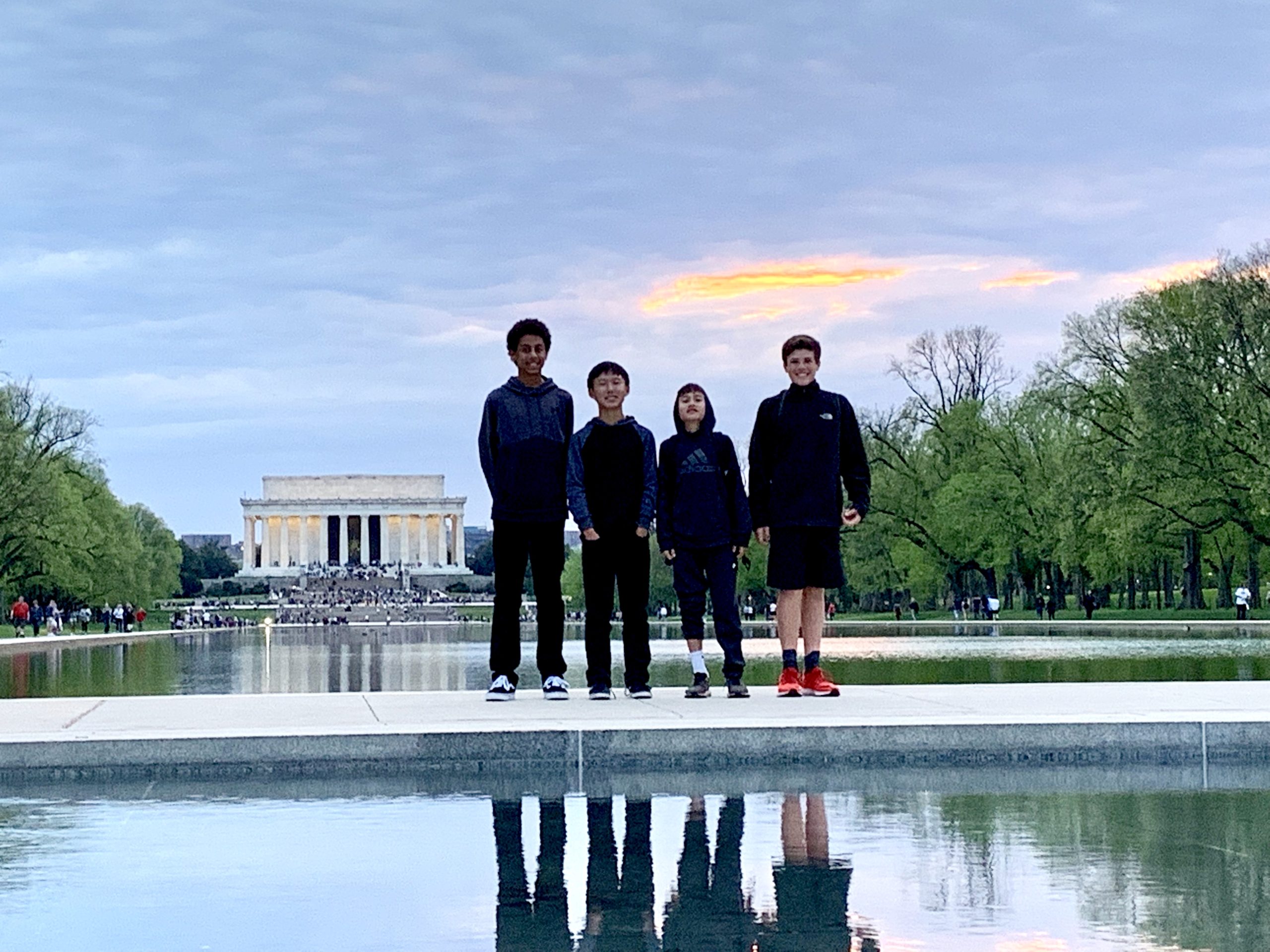four kids standing on pathway with the Lincoln Memorial in the background