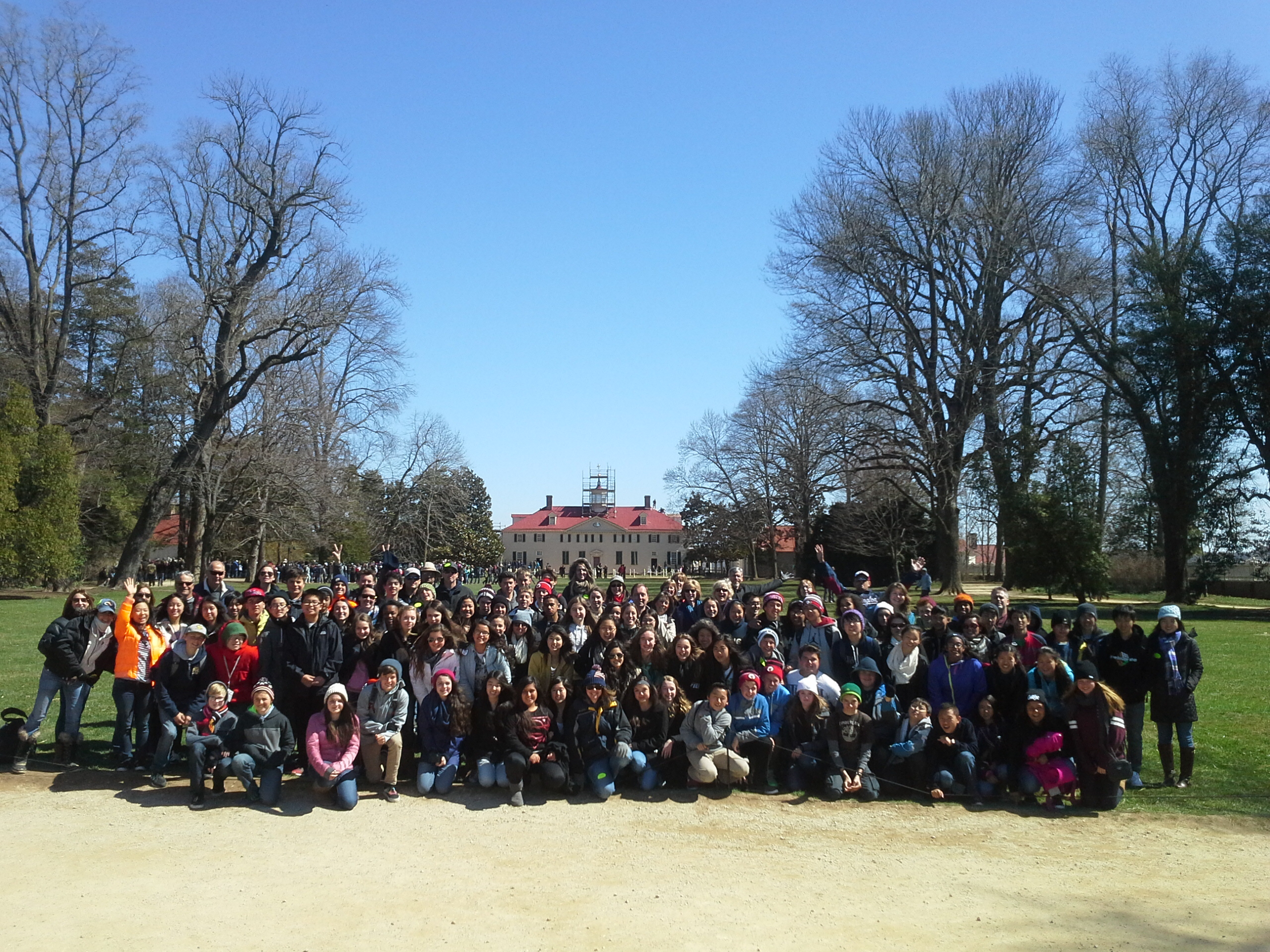 Group of students posing for photo in front of historical Mt Vernon house