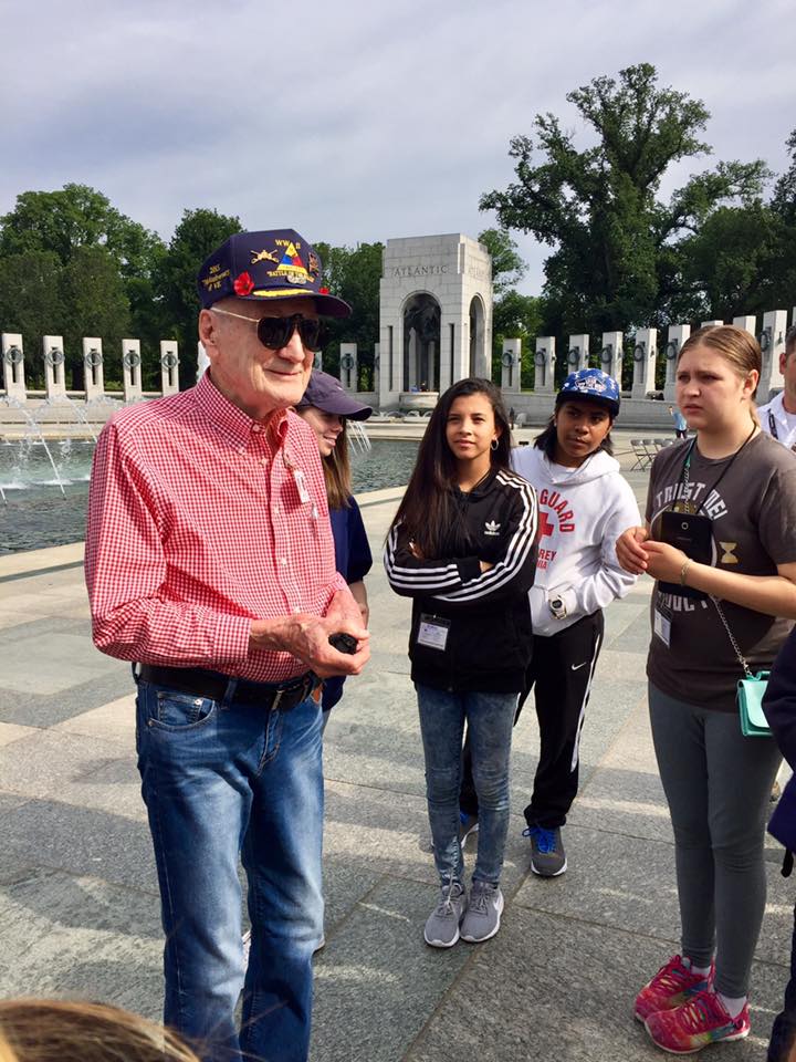 WWII Veteran talking to group of children at the WWII memorial in Washington DC