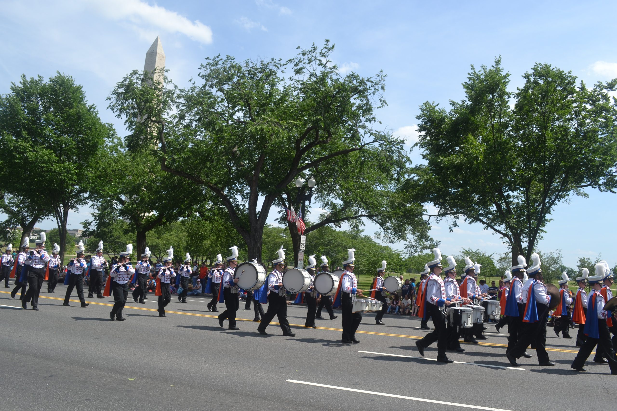 Marching band in street next to the Washington Monument in Washington DC