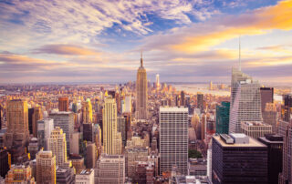 New York City view from a skyscraper looking directly at the Empire State Building.